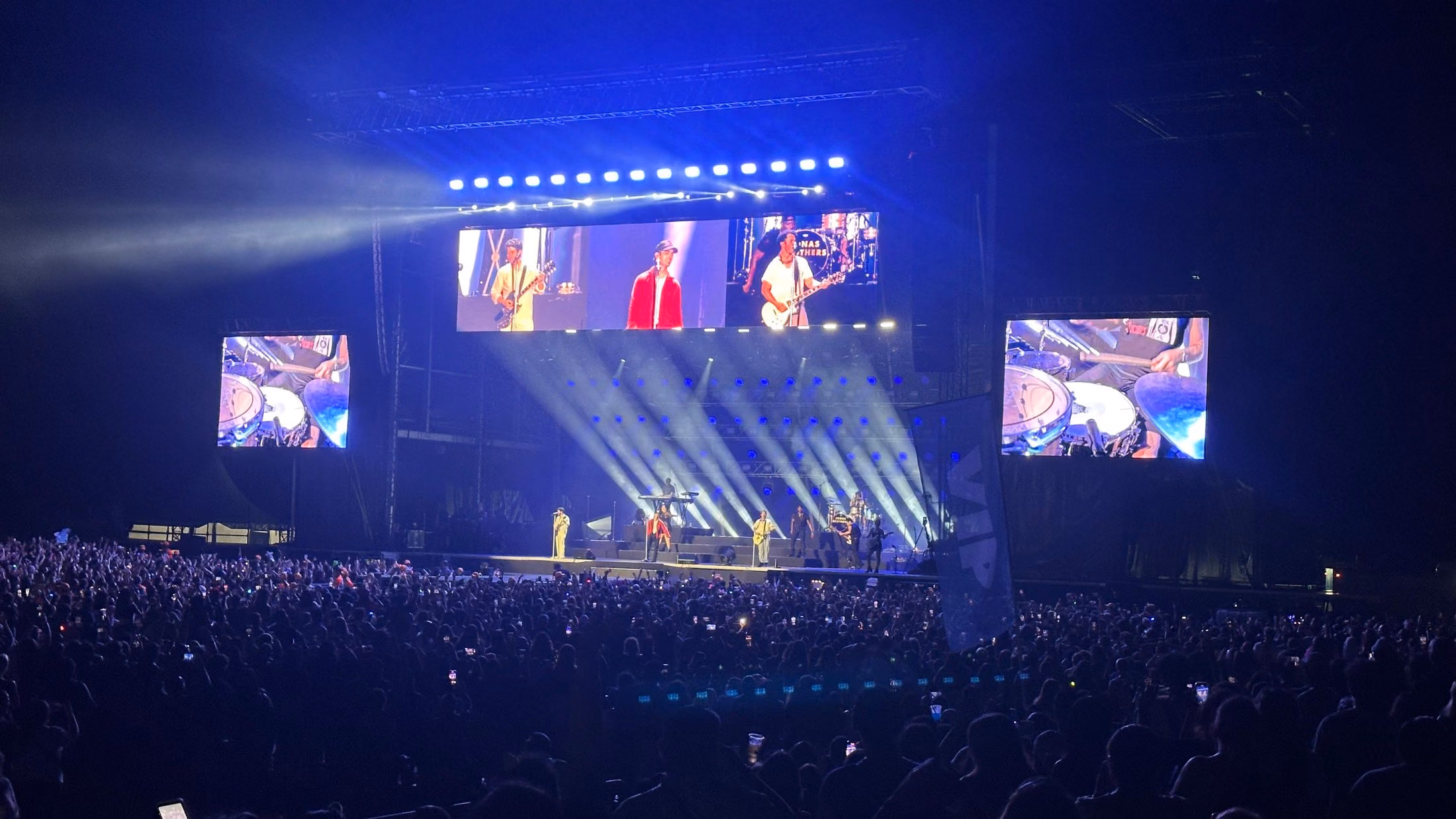 Concierto de Jonas Brothers en Cancún con pantallas de IMAG y público lleno de noche